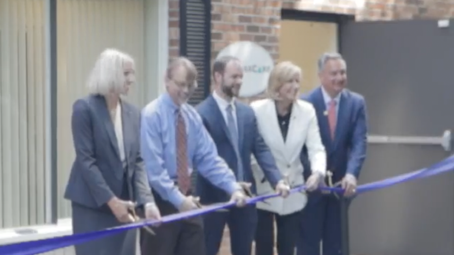 Photo of CompassCare CEO Jim Harden and NY leaders cutting a ribbon outside the Buffalo CompassCare office