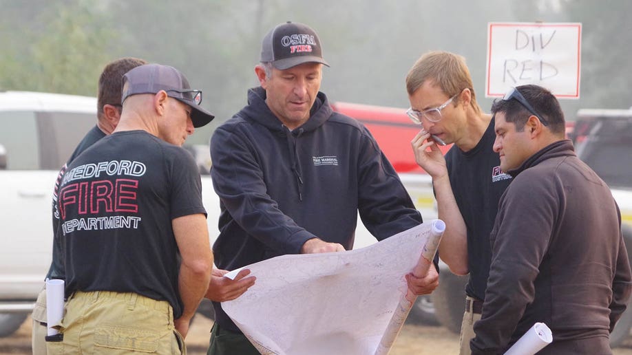 fire officials looking at maps