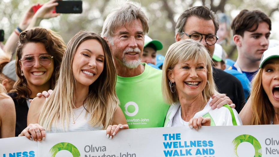 Olivia Newton-John with her husband and daughter