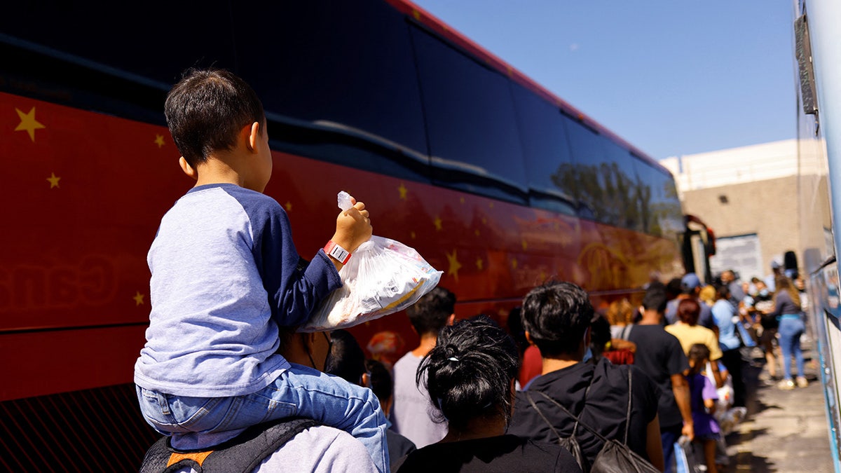 Migrants from Venezuela wait to board a bus in El Paso, Texas