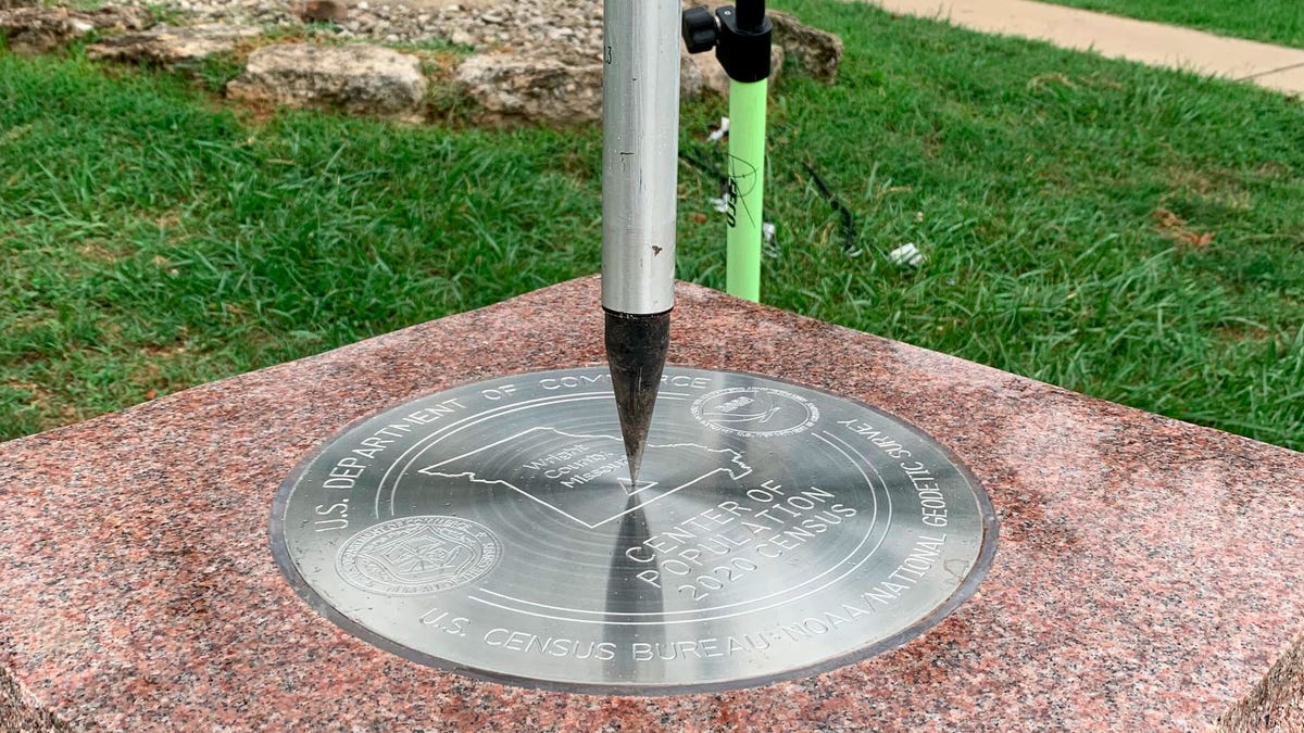 Tip of a tripod pointing to the 2020 Center of Population Commemorative Survey mark