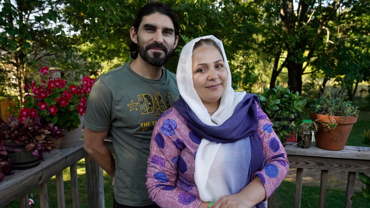 Man and woman in front of trees