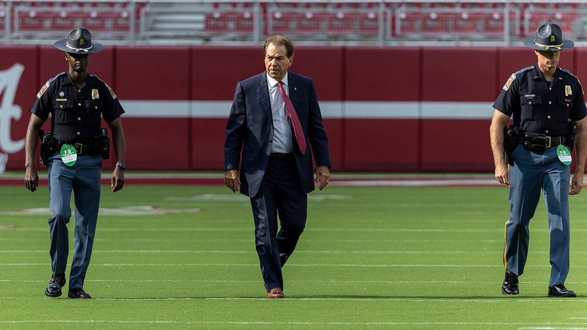 Nick Saban walks on the field prior to Utah State game