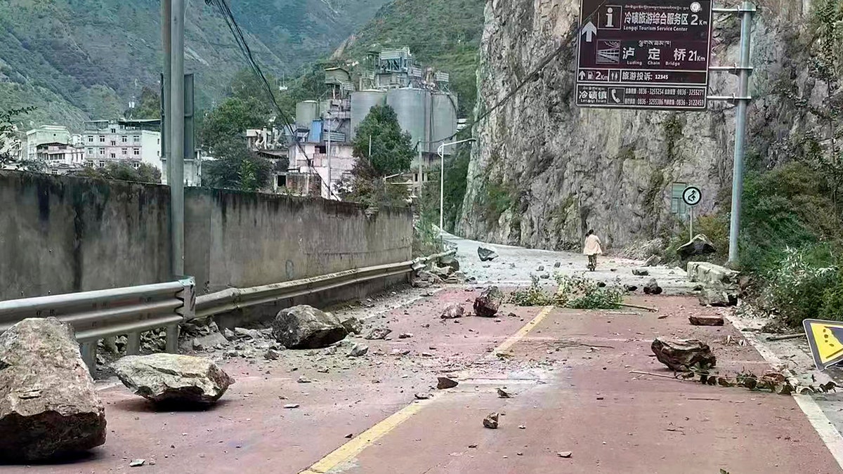 Debris is seen on a road after a major earthquake hit China