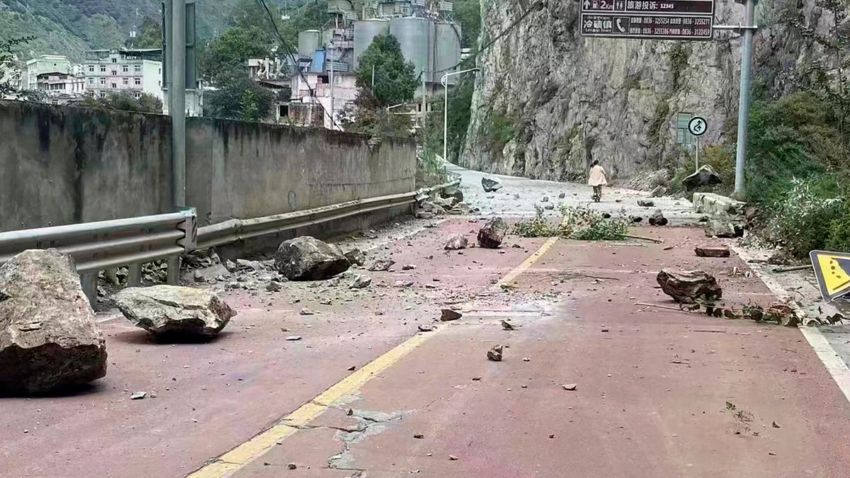 Debris is seen on a road after a major earthquake hit China