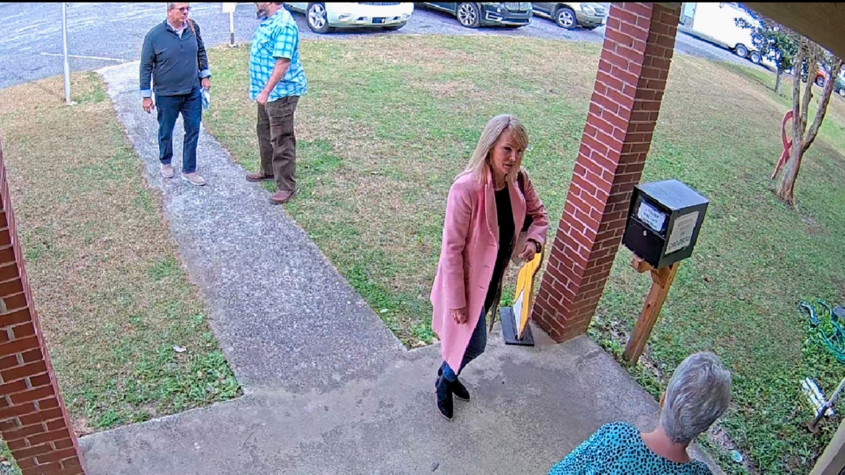 image taken from Coffee County, Ga., security video, Cathy Latham, bottom, who was the chair of the Coffee County Republican Party