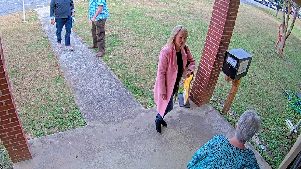 image taken from Coffee County, Ga., security video, Cathy Latham, bottom, who was the chair of the Coffee County Republican Party