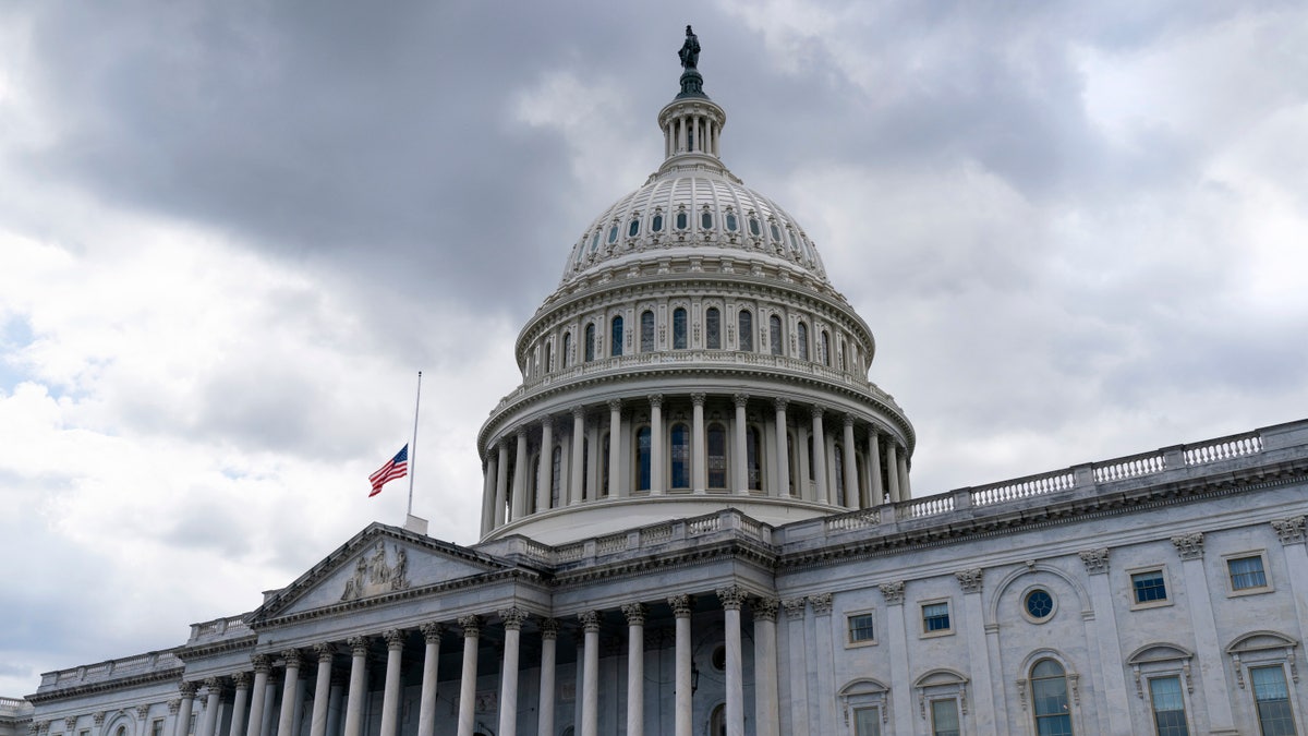 The American flag flies at half-staff over the U.S. Capitol