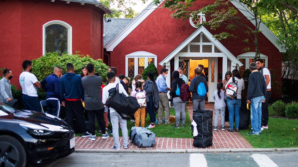 Migrants standing outside of a church on Martha's Vineyard.