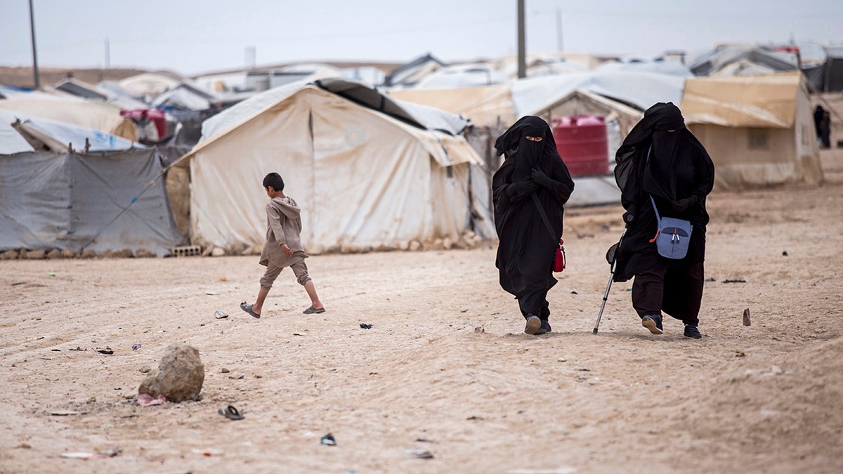 Women walking at al-Hol camp