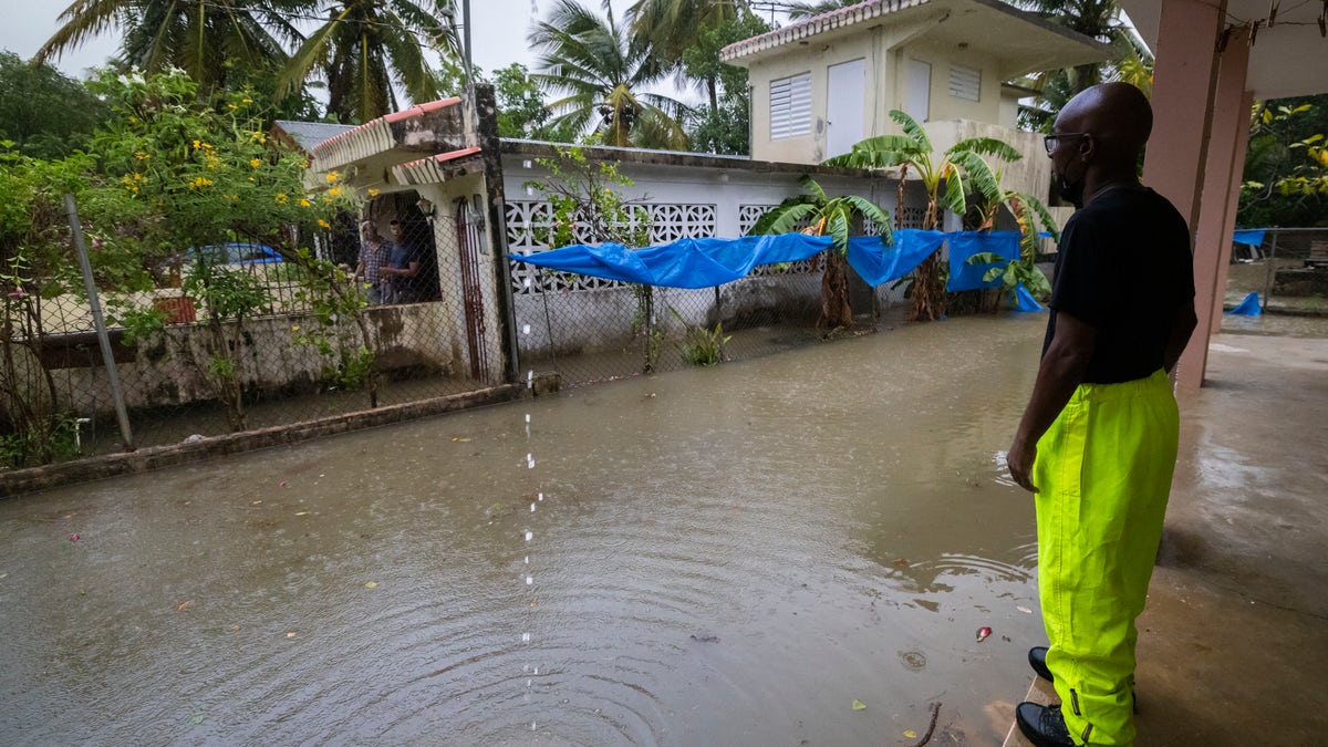 A man standing around high water caused by Hurricane Fiona in Puerto Rico