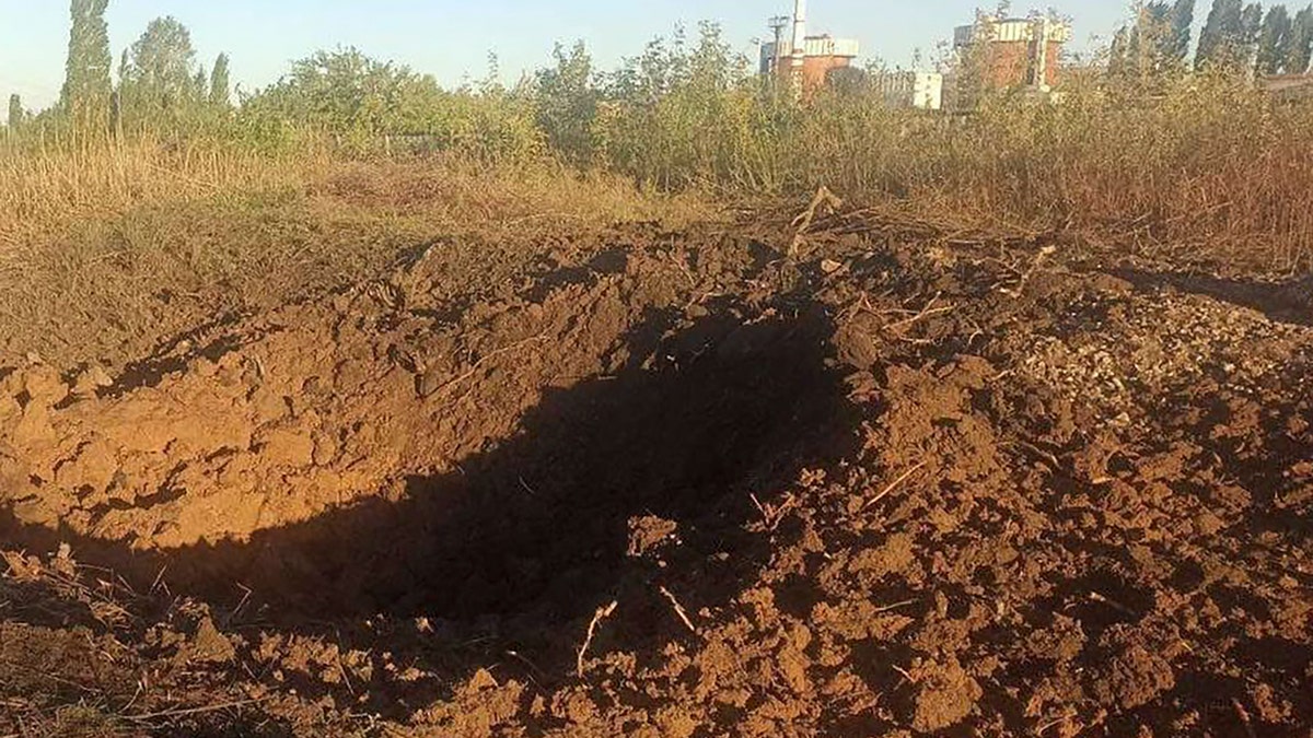 a crater left by a Russian rocket is seen 300 meter from the South Ukraine nuclear power plant