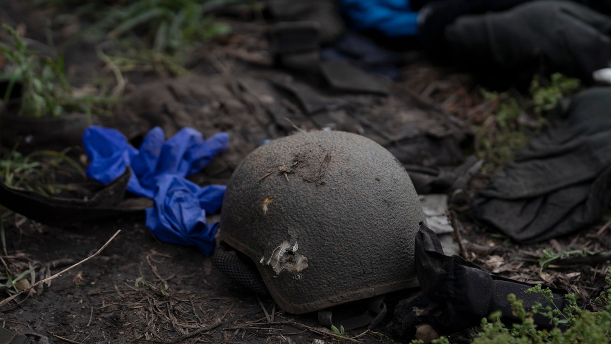 A damaged helmet is seen on the ground of a site where four bodies of Ukrainian soldiers where found