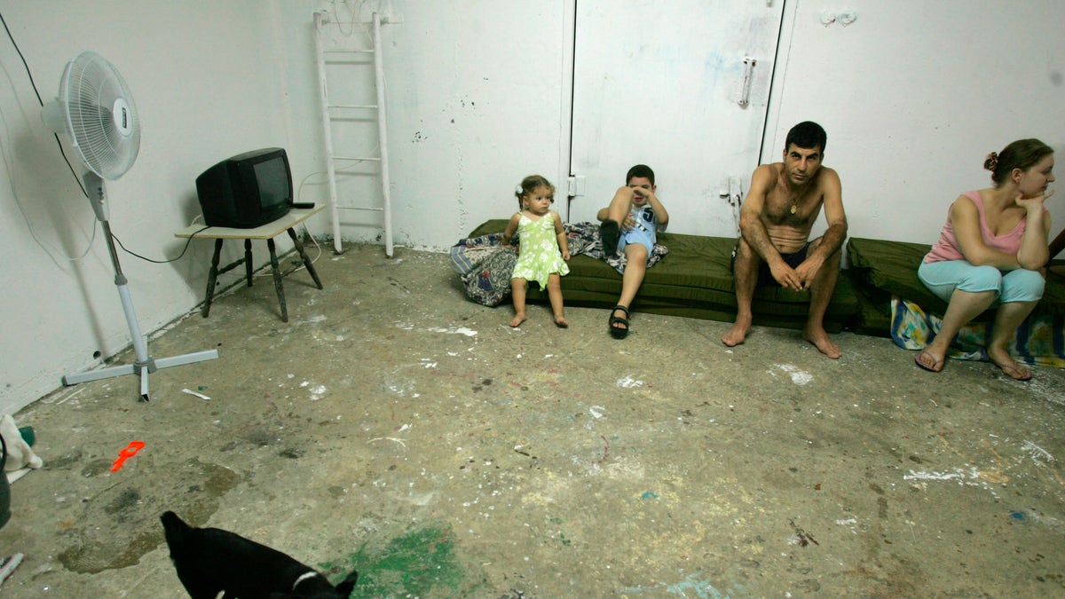 An Israeli family sits in a bomb shelter