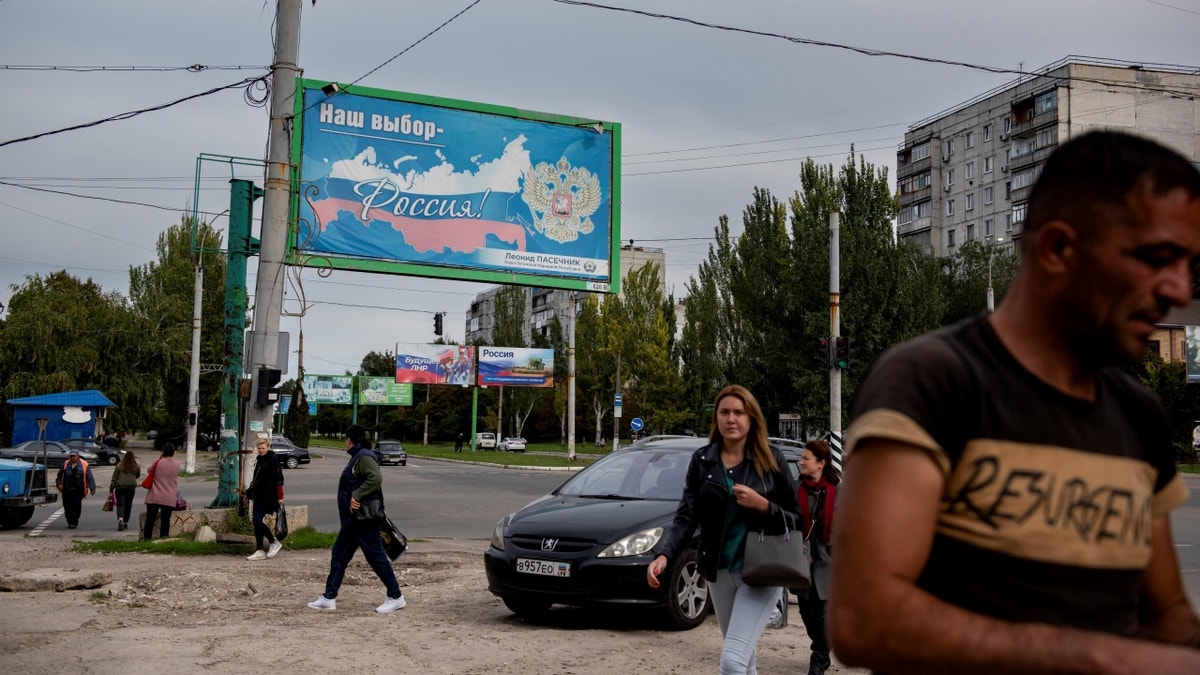 Russians walking near billboard