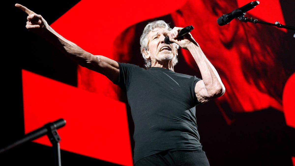 Roger Waters singing during a performance 