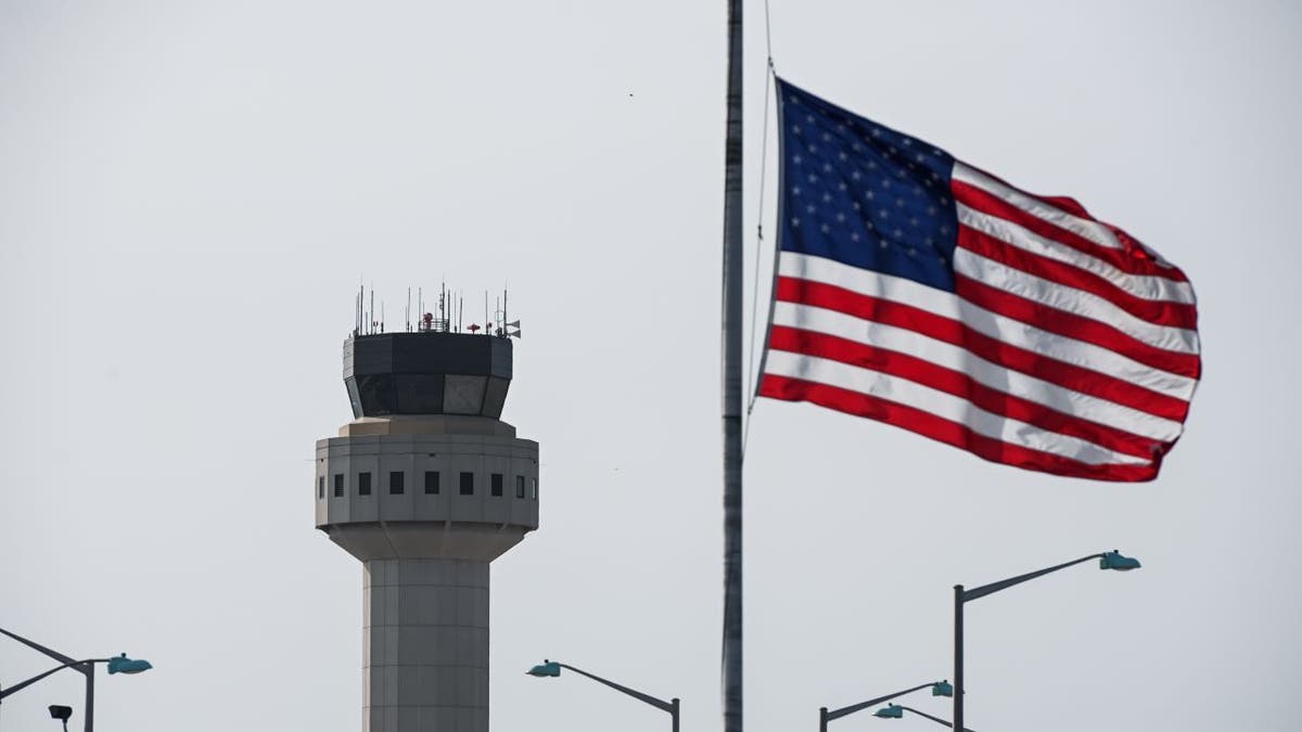 American flag flies in front of air traffic control tower in New York
