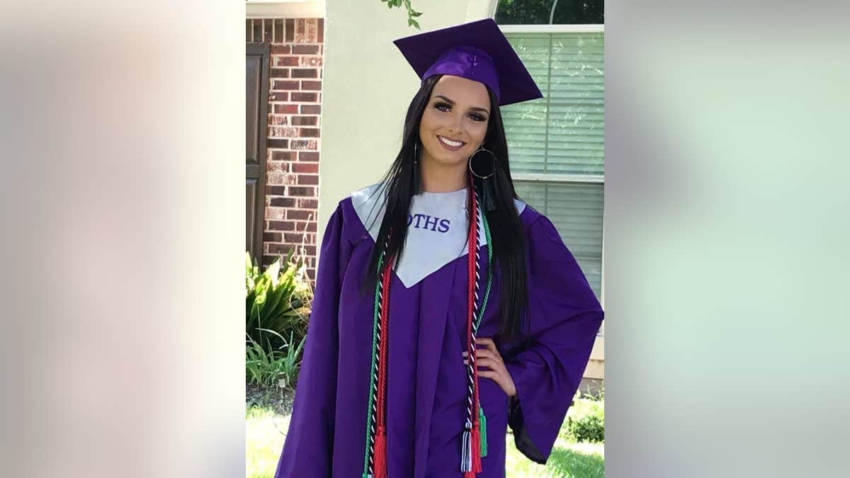 Allison "Allie" Rice in a purple robe and matching hat at her high school graduation