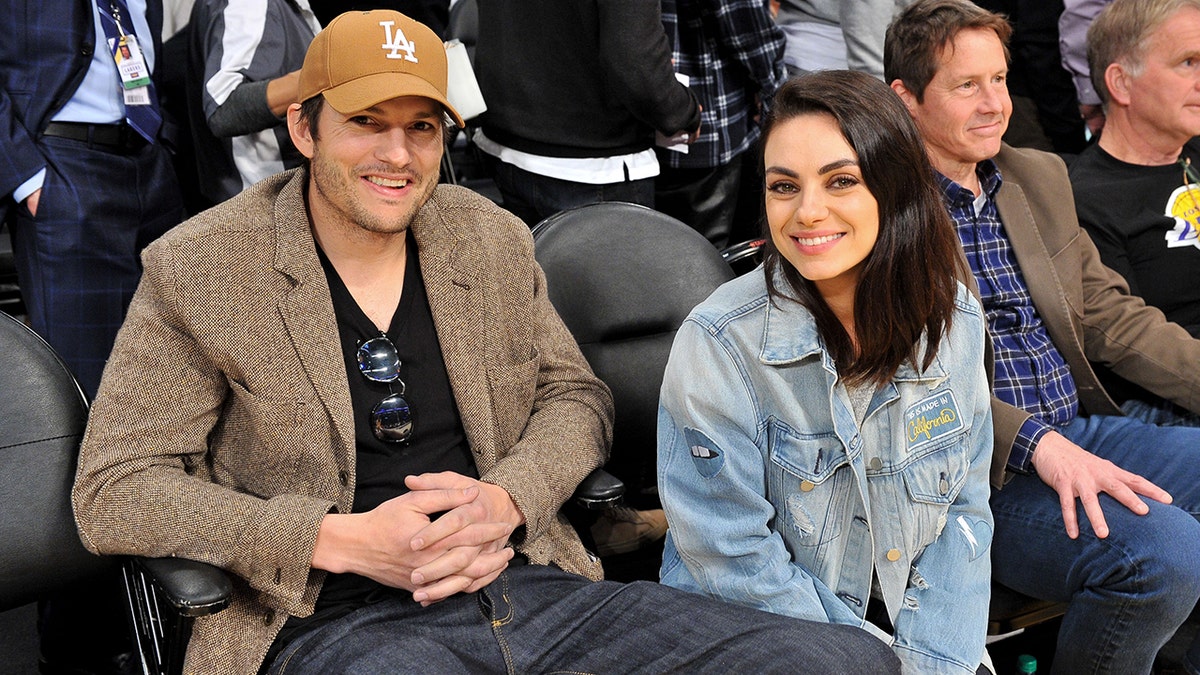 Mila Kunis and Ashton Kutcher smile