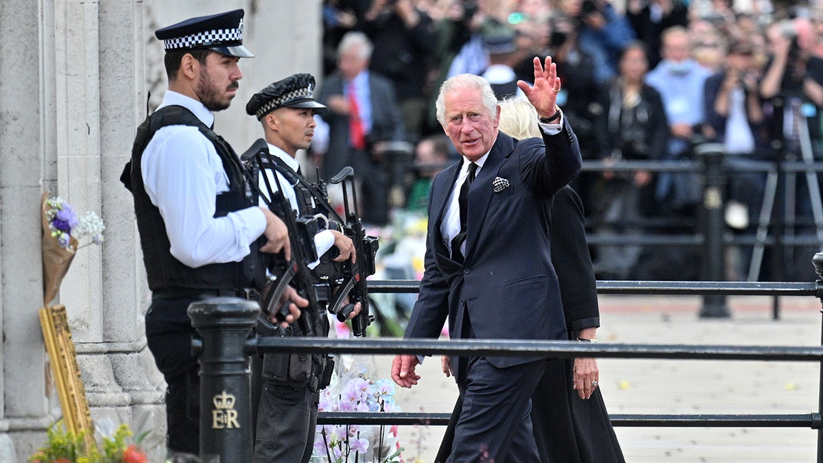 King Charles III greets people outside Buckingham Palace