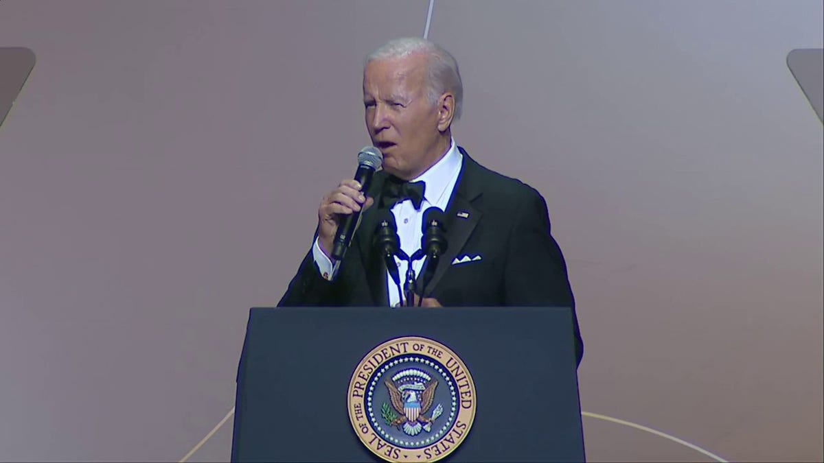 Biden speaking at a podium while wearing a tuxedo
