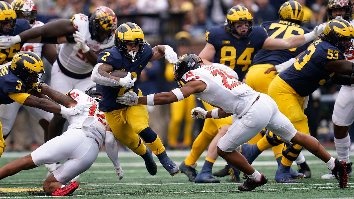 Running back Blake Corum runs against Maryland's defense