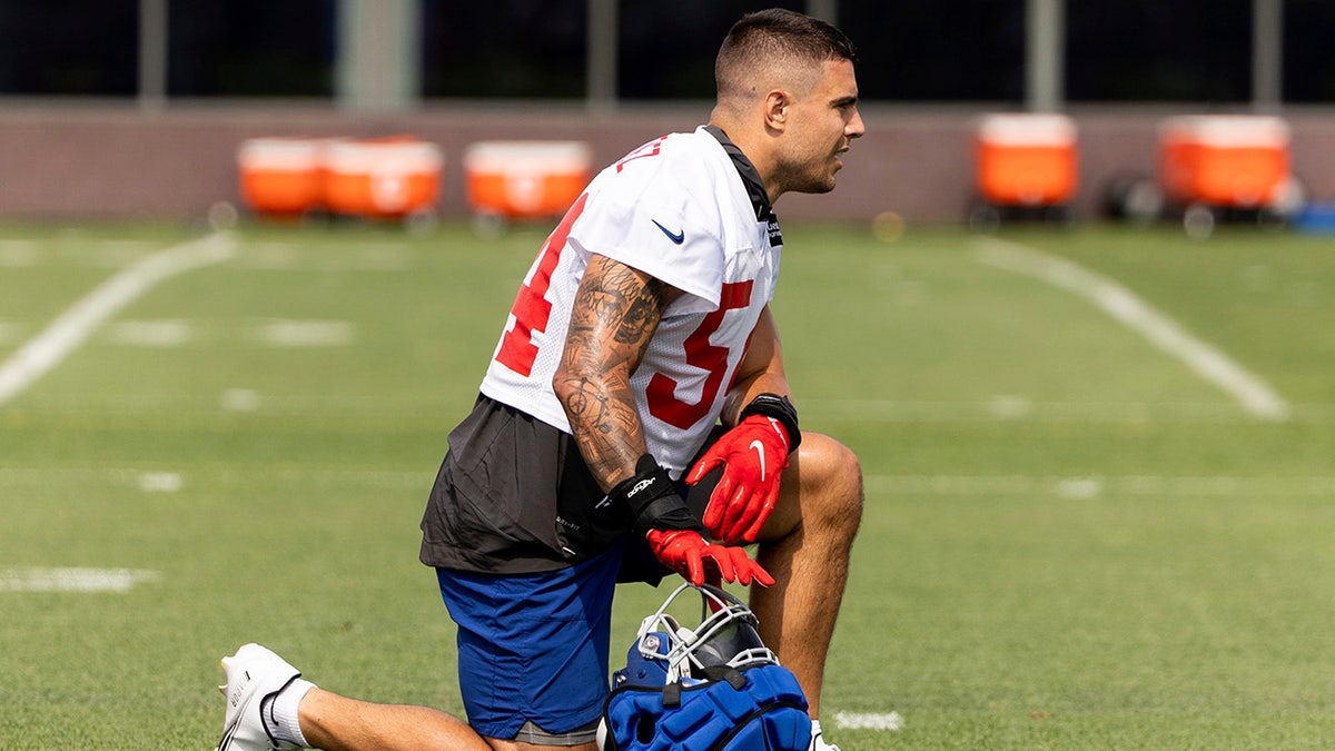 Blake Martinez kneeling during Giants training camp practice.