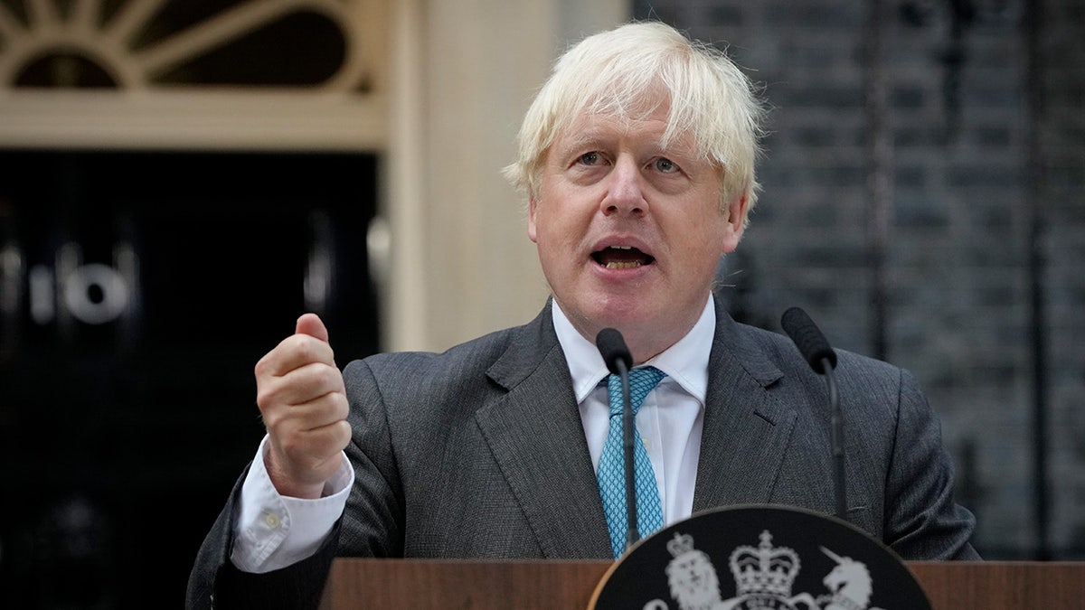 Boris Johnson speaks at podium at 10 Downing Street