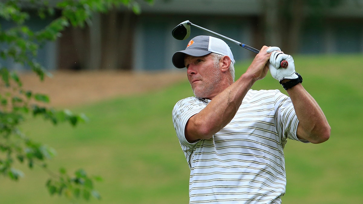 Brett Favre swings a club