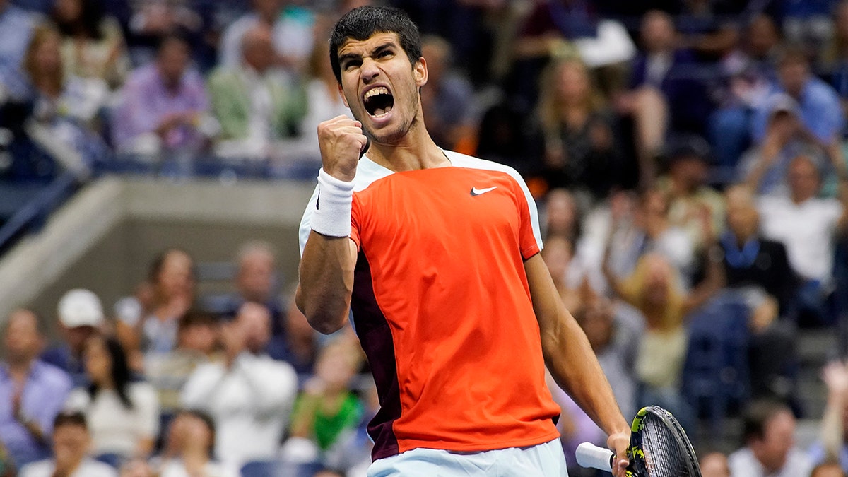 Carlos Alcaraz celebrating after scoring a point against Casper Rudd.