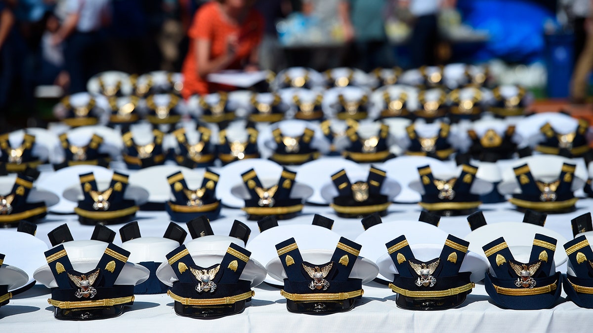 File photo of hats, shoulder bars at U.S. Coast Guard Academy commencement