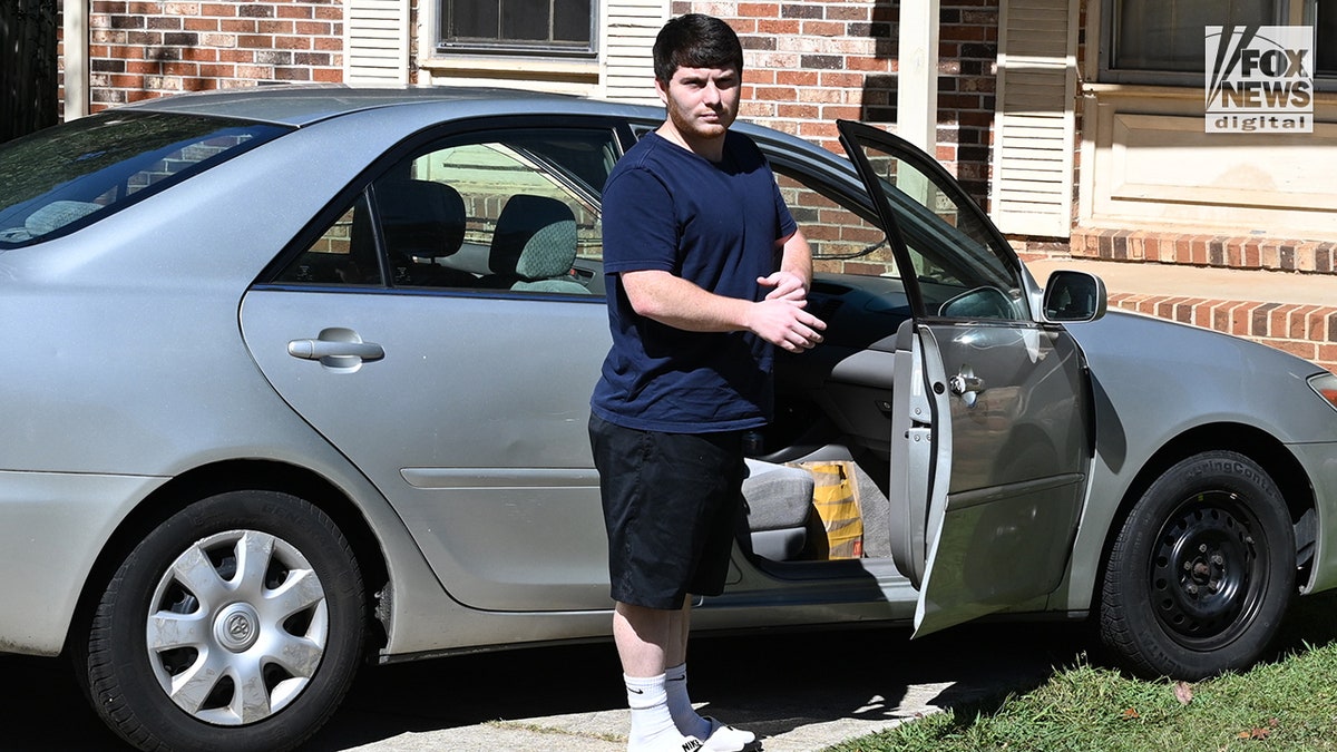 Andrew Giegerich alongside Amanda Bearden's car