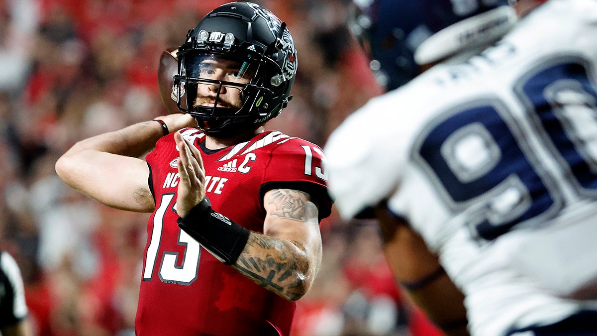 Devin Leary throws a pass