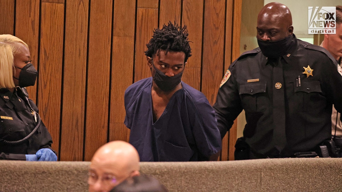 Ezekiel Kelly being led into courtroom