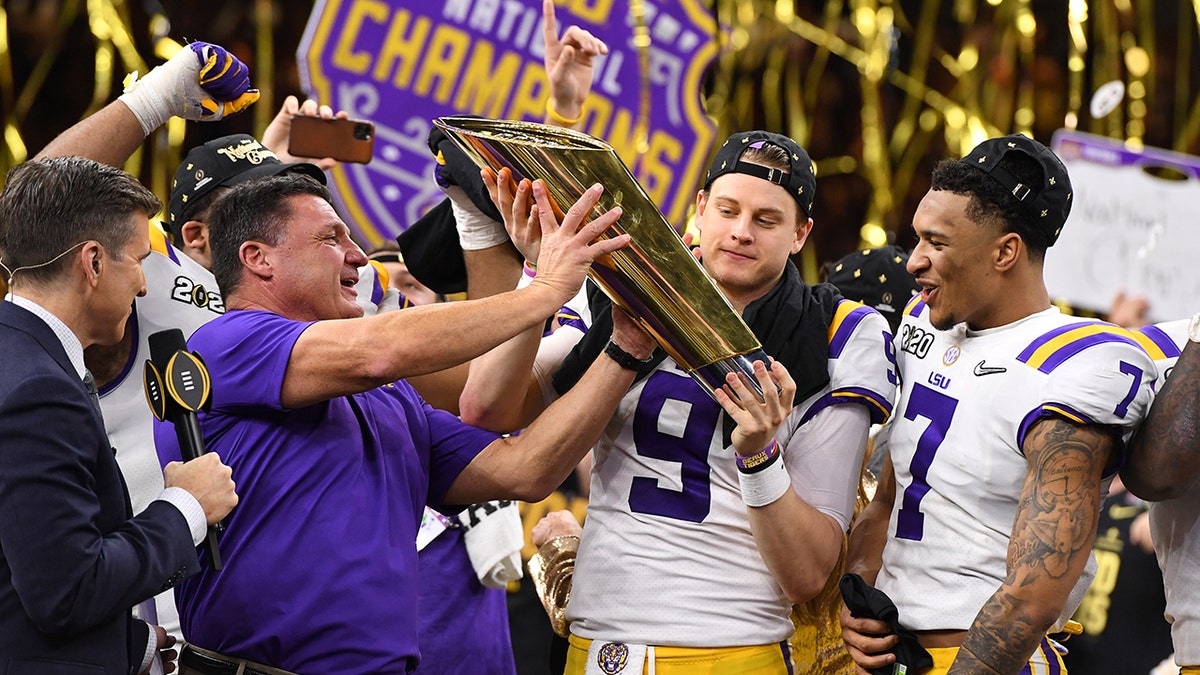 Ed Orgeron celebrates a national title