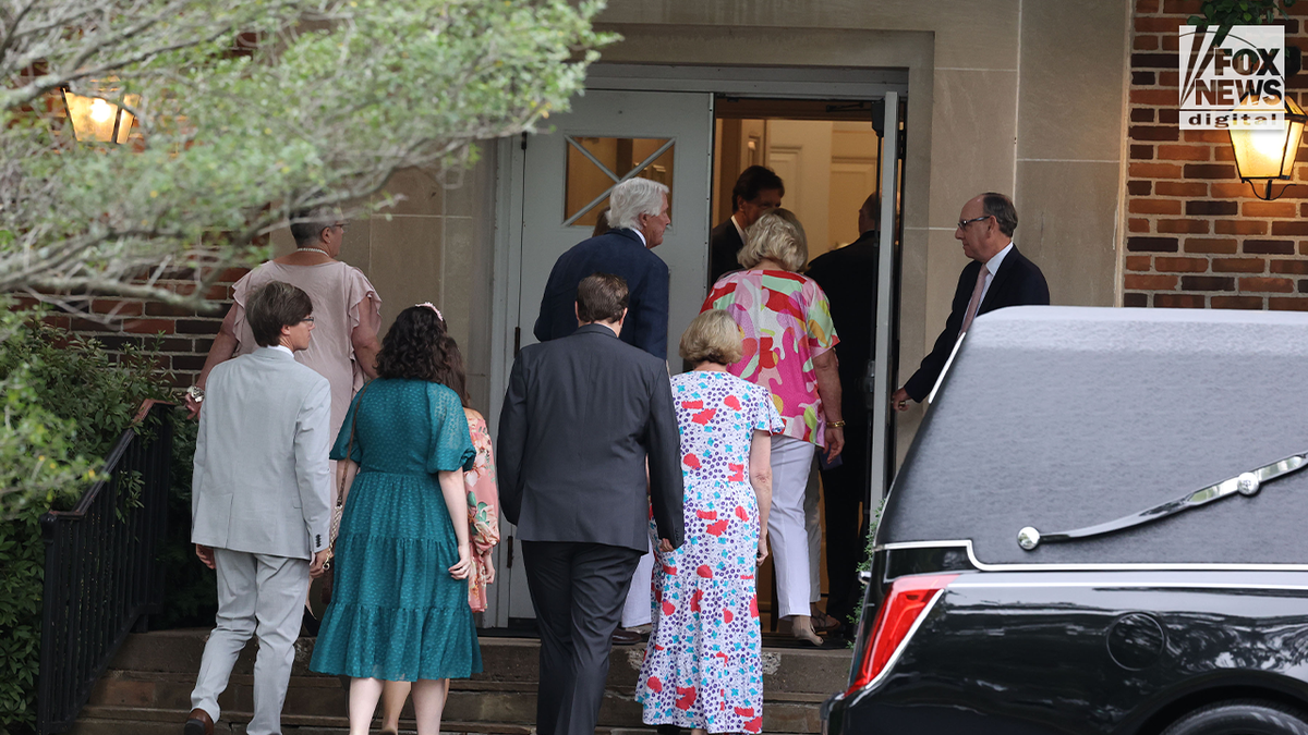 mourners entering church