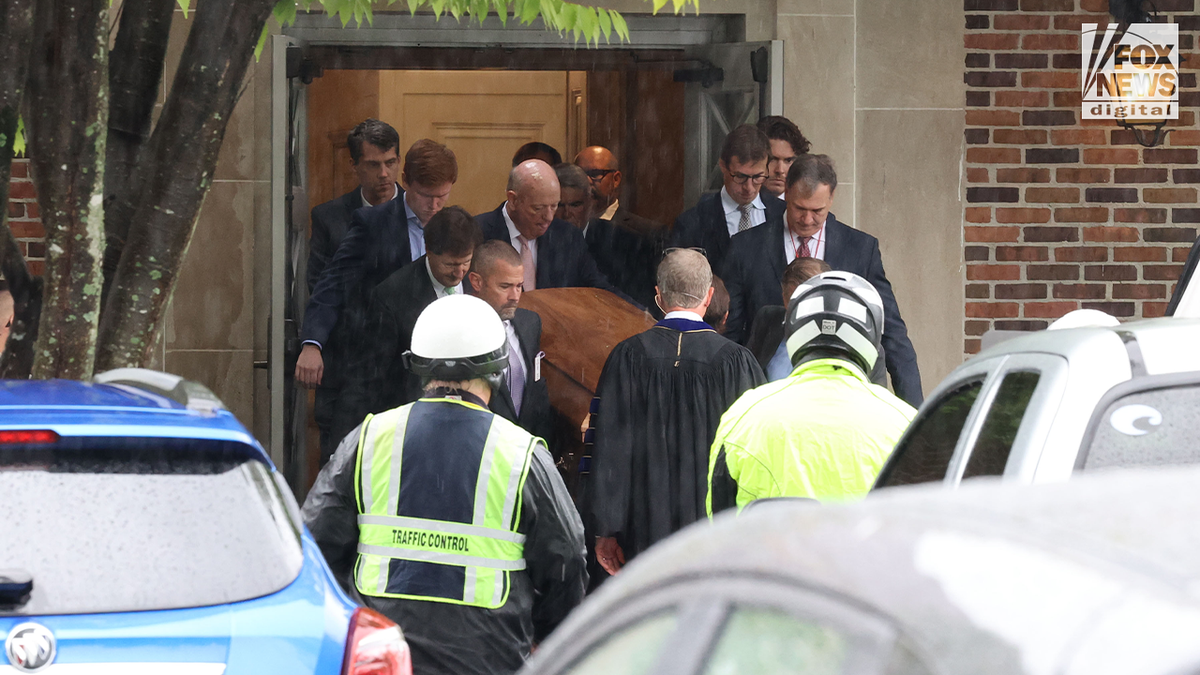 Mourners carrying Eliza Fletcher's casket out church