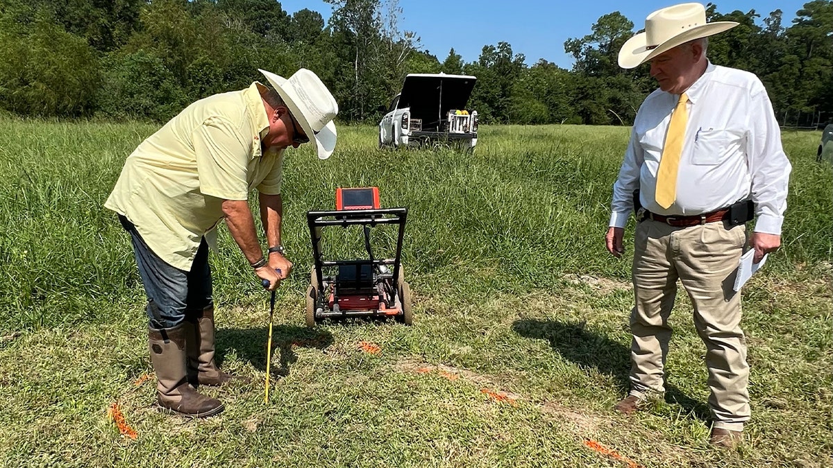 Investigators trace outline of buried object