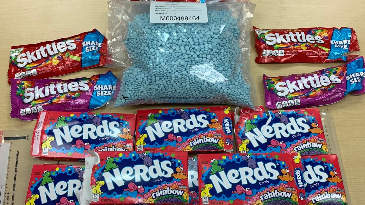 Bag of fentanyl at center with bags of candy around it candy
