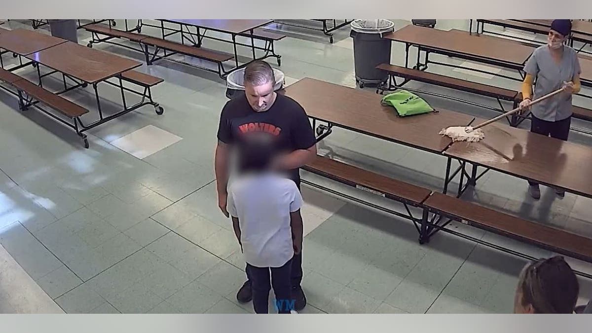Former principal Brian Vollhardt face to face with student before pushing him