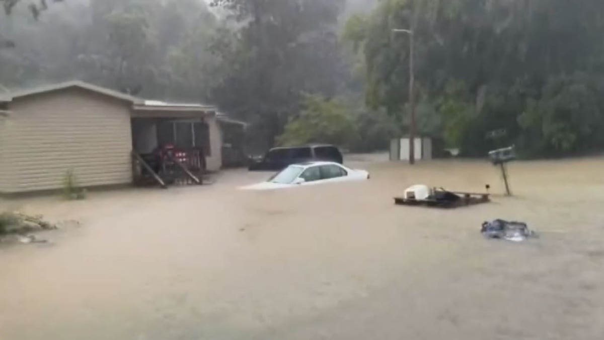 cars submerged and home flooded