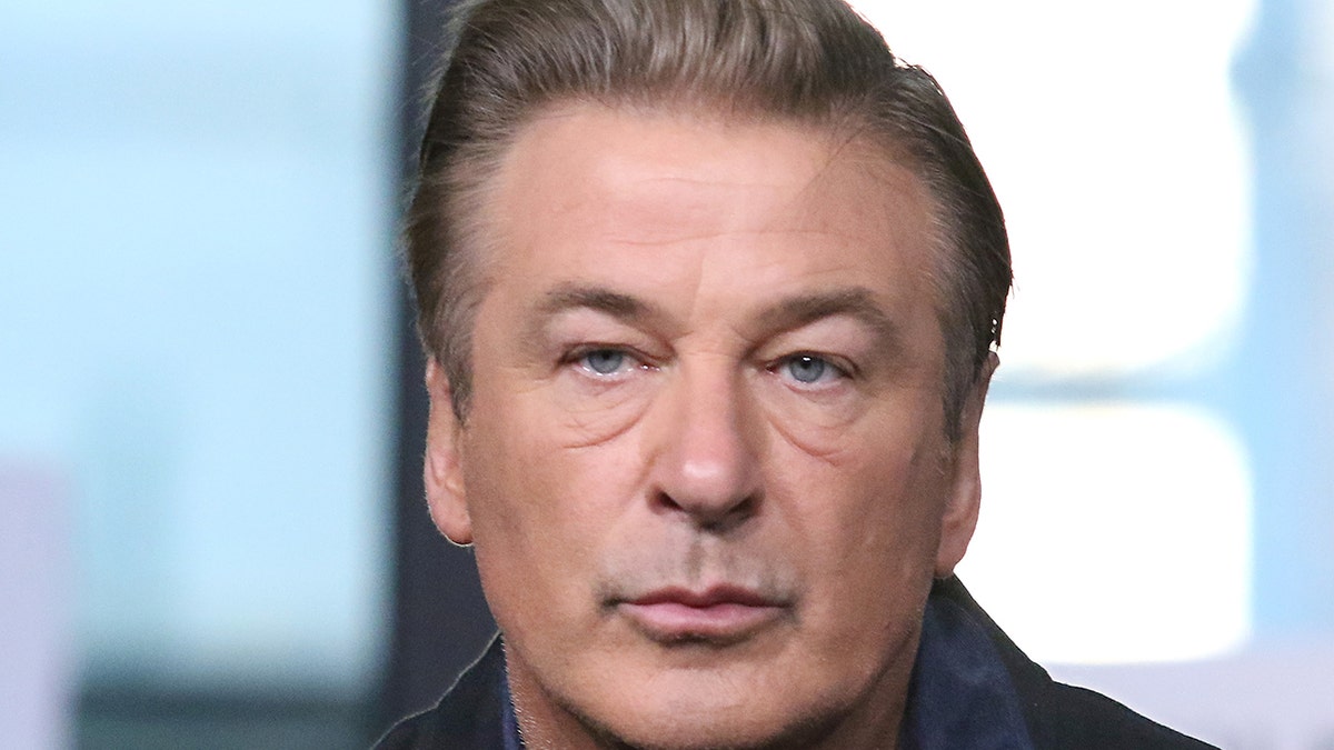 Alec Baldwin with pursed lips up close looking off-camera