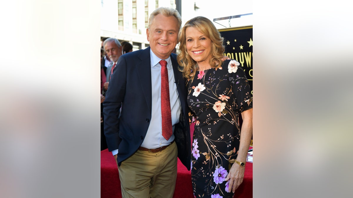 Pat Sajak with Vanna White on the red carpet.