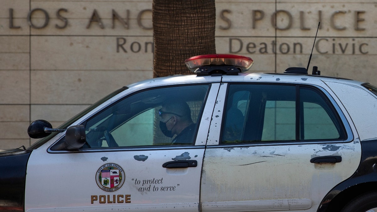 An LAPD officer sits in his vehicle