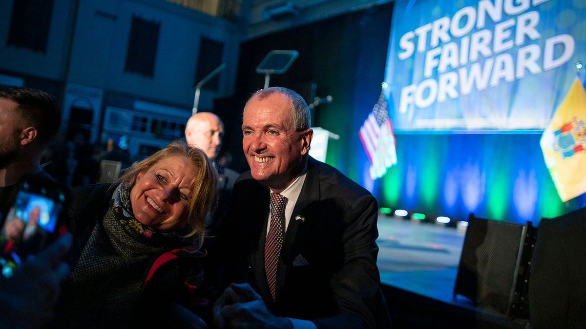 Phil Murphy smiles with supporter