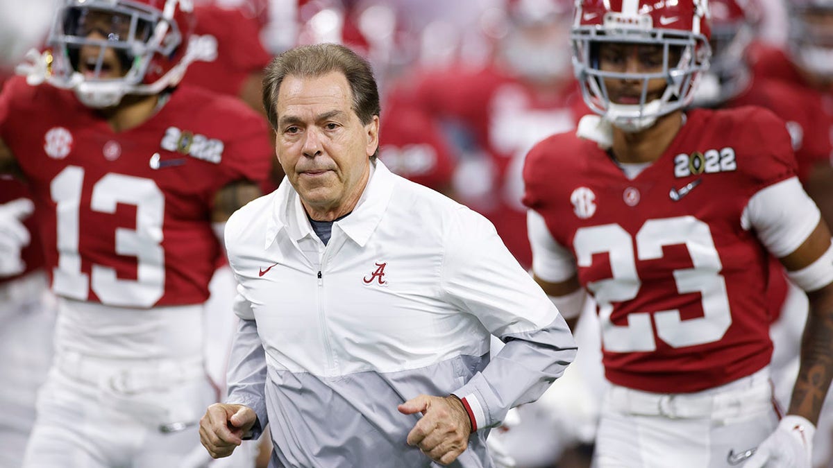 Nick Saban leads his team onto the field before the national championship game