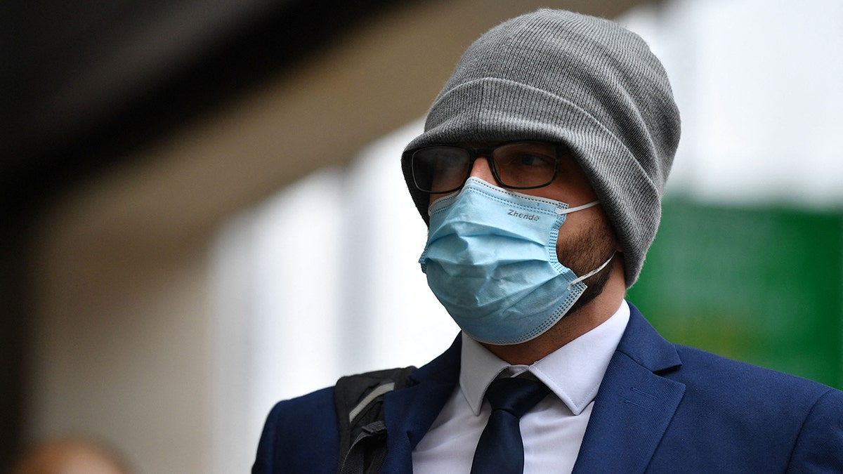 Jonathon Cobban wears mask and hat outside courthouse