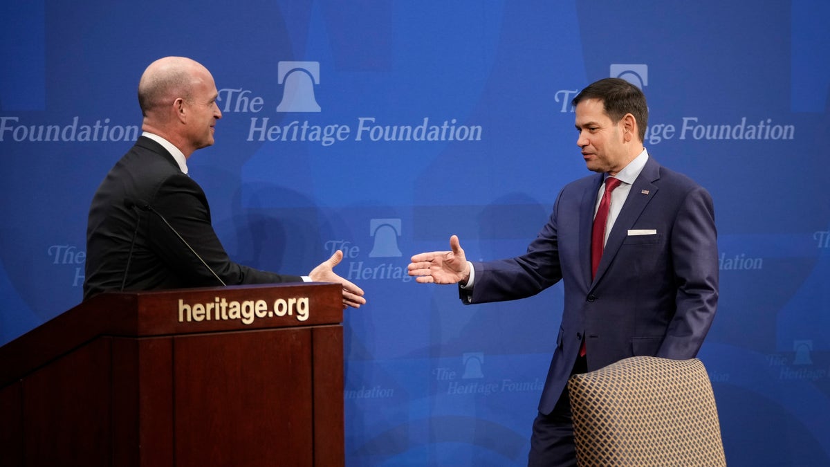 Heritage Foundation President Kevin Roberts shakes hands with Republican Sen Marco Rubio
