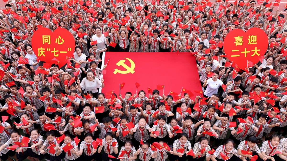 children holding mini People's Republic of China flags