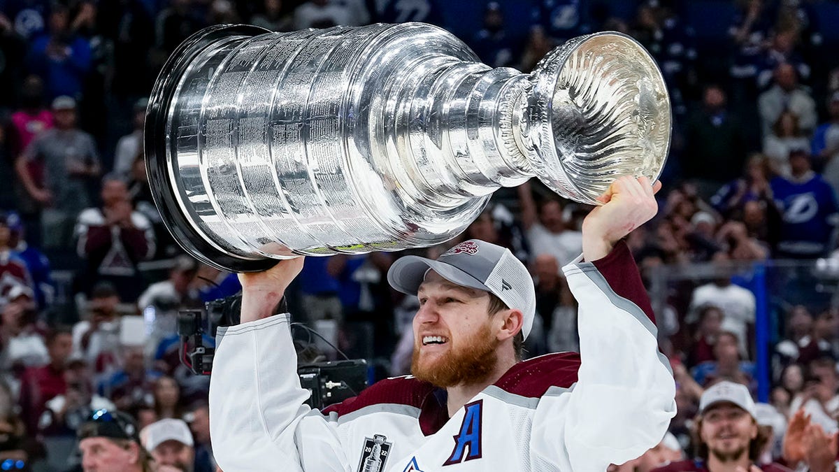 Nathan MacKinnon hoisting the Stanley Cup